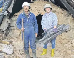  ??  ?? Michiko Setoyama with her “master” Kenichi Sudo, 60, in front of a charcoalbu­rning hut in the village.