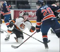  ?? NEWS PHOTO RYAN MCCRACKEN ?? Medicine Hat Tigers centre Logan Christense­n clogs up a shooting lane during a Western Hockey League game against the Regina Pats at the Canalta Centre on Friday.