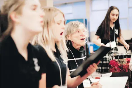  ?? PHOTOS BY SUSANNE AHEARNE, UVIC ?? Gracia Seal, centre, and St. Andrew’s Regional High School students (from left) Jessica Coady, Claire O’Neill and Mari Chambers practise with the Voices in Motion intergener­ational choir. The choir is part of a research project on dementia led by...