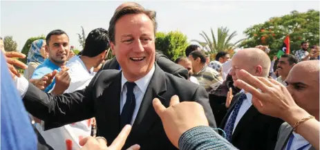  ?? ?? Fleeting victory: David Cameron at the Tripoli Medical Centre in Libya after the fall of Gaddafi in 2011