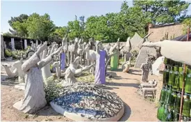  ?? Nick Yell ?? Looking east: Some of Helen Martins’ myriad unconventi­onal cement-and-wire sculptures in her ‘Camel Yard’ all appearing to wait for Christ’s second coming. /