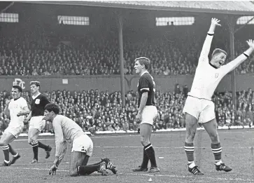  ??  ?? Delirious with delight, Finn Dossing raises his arms in joy as he scores Dundee United’s second at Dens in 1965. Dossing scored a hat-trick in the game, which United won 5-0.