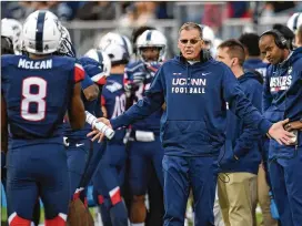  ?? BRAD HORRIGAN / HARTFORD COURANT ?? Connecticu­t head coach Randy Edsall asks Huskies wide receiver Aaron McLean about a play during a game against South Florida last season. Edsall says he knows he can make UConn a winner once again.