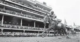  ?? JEFF ROBERSON/AP ?? Rich Strike, with Sonny Leon aboard, wins the 148th running of the Kentucky Derby on Saturday at Churchill Downs in Louisville, Kentucky.