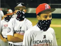  ??  ?? Mason Runow (L) and Dede Mance are two of about 200 boys and girls who participat­e in the Admirals’ baseball and softball programs. The club is currently practicing with masks, social distancing and without shared equipment at Vacaville Christian High School.