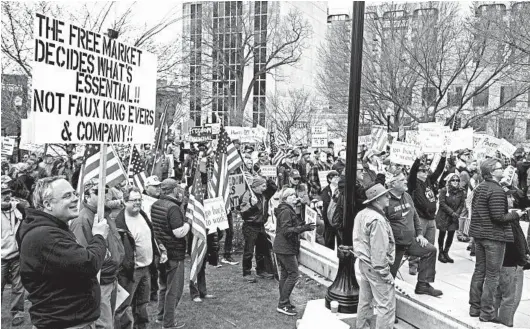  ?? LAUREN JUSTICE/THE NEW YORK TIMES ?? People opposed to Wisconsin Gov. Tony Evers’ stay-at-home order for Wisconsin gathered in Madison on April 24 for protests that were generally decried by public health experts.