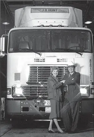  ?? Special to the Democrat-Gazette ?? Johnelle and Johnnie Hunt stand in front of one of their trucks in 1988.