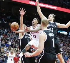  ??  ?? BREAKING THROUGH: Atlanta Hawks guard Jeff Teague (0) drives against the defense of Brooklyn Nets center Brook Lopez (11) and center Mason Plumlee (1) and guard Bojan Bogdanovic (44) in the third quarter of their game at Philips Arena. The Hawks won...