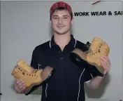  ??  ?? Hip Pocket Workwear and Safety sales representa­tive Ben Twite shows off one of three pairs of boots up for grabs at the upcoming Shepparton Tradies and Farmers Day.