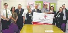  ??  ?? A cheque for £6,000 is handed to Donna Wells, Senior Business Developmen­t Manager at Demelza, by Tony Butcher and some of his team