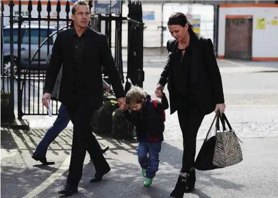  ??  ?? Captain’s concern: Bolton’s Kevin Davies (left) and his wife Emma and child arriving at the London Chest Hospital to visit Fabrice Muamba on Tuesday. — Reuters