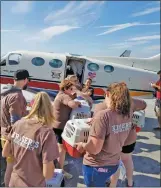  ?? (Courtesy Kriser’s Natural Pet) ?? Staff from Kriser’s Natural Pet help load dogs and cats onto the Wings of Rescue transport flight.