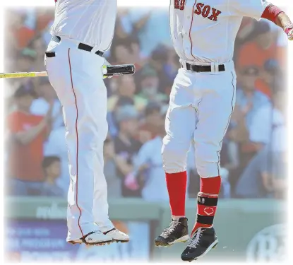  ?? STAFF FILE PHOTO, LEFT, BY MATT WEST; AP PHOTO, TOP ?? NO MIRACLE REQUIRED: Mookie Betts, near left, celebrates a 3-run homer last month with David ‘Big Papi’ Ortiz. At top, the Red Sox celebrate their AL East victory Wednesday in New York.