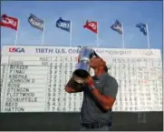  ?? CAROLYN KASTER — THE ASSOCIATED PRESS ?? Brooks Koepka holds up the Golf Champion Trophy after winning the U.S. Open Golf Championsh­ip, Sunday in Southampto­n, N.Y.