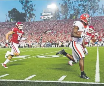  ?? Harry How, Getty Images ?? Georgia running back Sony Michel trampled Oklahoma’s defense in the Rose Bowl, gaining 181 yards on only 11 carries. He averaged 16.5 yards per rush and scored the winning TD.