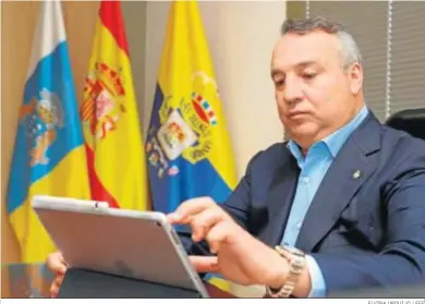  ?? ELVIRA URQUIJO / EFE ?? Miguel Ángel Ramírez, presidente de Las Palmas, consulta su ‘tablet’ en su despacho.