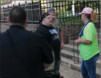  ?? (Arkansas Democrat-Gazette/Dale Ellis) ?? Sheryl Selby (right) talks Saturday with Dustin Spruill, the organizer of the Black Lives Matter protest in Sheridan. Selby was with a group of onlookers who crossed the street to the courthouse to talk with the protesters. At one point, the confrontat­ion grew heated enough to prompt police to move in closer.