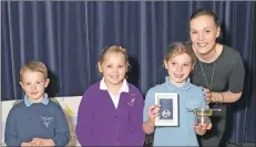  ??  ?? Fiona Fyfe presents the P3 and P4 category winners – Kirsty Hume, Daisy Campbell and Alfie Gilmore in third place.