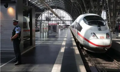  ??  ?? A police officer stands on a deserted platform Frankfurt’s main train station on Monday. Photograph: Armando Babani/EPA