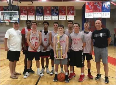  ?? Photo by Branden Mello ?? The Lincoln boys basketball team battled back from a double-digit first-half deficit to defeat Woonsocket, 57-48, to claim the 2019 Mount St. Charles Summer League title Sunday night. Senior point guard Josh Jahnz holds the trophy.