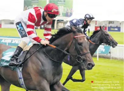  ??  ?? ■ Sinjaari ridden by Stevie Donohoe winning The John Smith’s Cup Handicap at York