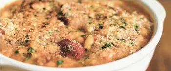  ?? JONELLE WEAVER/TNS ?? Using sausage over more traditiona­l duck confit or goose gives this casserole an American touch.