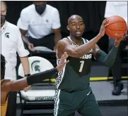  ?? AL GOLDIS — THE ASSOCIATED PRESS ?? Michigan State’s Joshua Langford looks to pass against Oakland’s Rashad Williams, seen a left, during the second half of a Dec. 13 game in East Lansing.