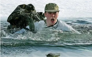  ??  ?? Fighting fit: A Royal Marine takes an icy plunge during training in Norway