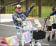  ?? LAUREN A. LITTLE — MEDIANEWS GROUP ?? Birdsboro Lodge resident Joe Pinder waves at a parade of familes in their cars.