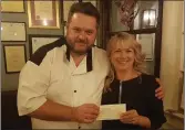  ??  ?? Croí Restaurant head chef Noel Keane presents a cheque for €2,880 to Margaret O’Halloran on behalf of the Cycle Against Suicide charity
