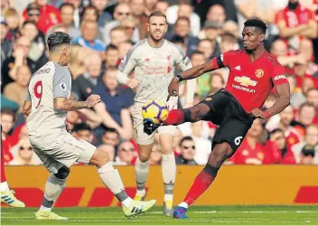  ?? Picture: REUTERS/LEE SMITH ?? TOUGH MATCH: Manchester United’s Paul Pogba in action with Liverpool’s Roberto Firmino, left, at Old Trafford in Manchester on Sunday. The match ended in a goalless draw.