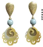  ??  ?? Hand-carved shell earrings with jade in brass metal finish.