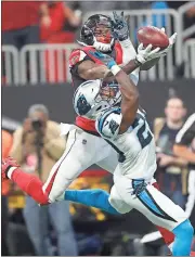  ?? John Bazemore / AP ?? Atlanta wide receiver Julio Jones (back) goes for a ball against Carolina strong safety Mike Adams.