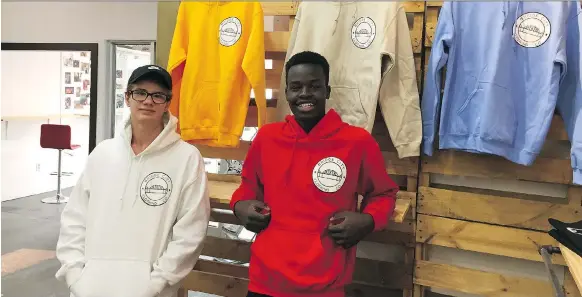  ?? ERIN PETROW ?? Bridge City Clothing Company creators Grayson Isley, left, and Emmanuel Yusuf are seniors in high school who are serious about creating quality, affordable clothes for teens. The clothes are available for purchase online and at Uno Printing Co.’s downtown location.