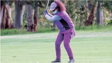  ??  ?? Sue Hatfield plays a driver from the centre of the first fairway during her round on Saturday morning.