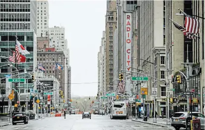  ?? FRANK FRANKLIN II THE ASSOCIATED PRESS ?? Pedestrian­s walk a mostly empty Sixth Avenue in New York City. The state’s governor, Andrew Cuomo, has characteri­zed his move to seize ventilaors from private hospitals and companies that aren’t using them as a “sharing of resources.”