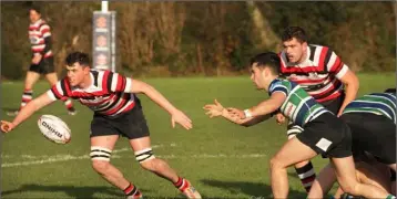  ??  ?? Jim White of Enniscorth­y keeps a close watch on the recipient of Stephen Horan’s pass in the local derby.