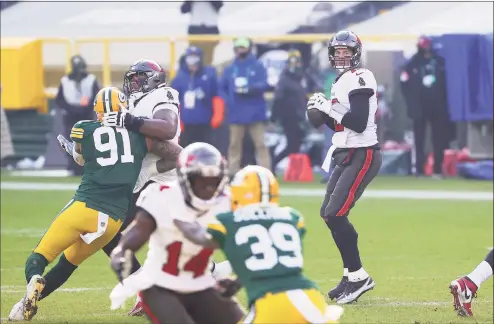  ?? Stacy Revere / TNS ?? Buccaneers quarterbac­k Tom Brady looks to pass in the first quarter against the Green Bay Packers during the NFC championsh­ip game on Sunday in Green Bay, Wis.