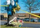  ?? ALEX BRANDON/AP ?? Flowers and balloons stand Wednesday near the Chesapeake Walmart.