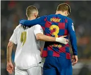  ??  ?? Real Madrid’s Karim Benzema, left, and Barcelona’s Gerard Pique leave the pitch together at the end of the La Liga match.