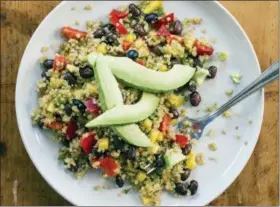  ?? DANIEL J. VAN ACKERE — AMERICA’S TEST KITCHEN VIA ASSOCIATED PRESS ?? This undated photo provided by America’s Test Kitchen in May 2018shows a quinoa, black bean and mango salad in Brookline, Mass. This recipe appears in the cookbook “Vegan For Everybody.”