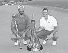  ?? ANDREW REDINGTON/ GETTY IMAGES ?? Jon Rahm, left, won the DP World Tour Championsh­ip trophy and Rory McIlroy the Harry Vardon points trophy.