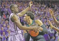  ?? ORLIN WAGNER/ASSOCIATED PRESS ?? Baylor forward Freddie Gillespie, right, is covered by Kansas State forward Makol Mawien during the first half of Monday’s game in Manhattan, Kan.