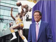  ?? Reed Saxon / Associated Press ?? Elgin Baylor stands next to a statue honoring the Minneapoli­s and Los Angeles Lakers great outside Staples Center in Los Angeles. Baylor died Monday of natural causes.