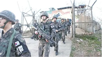  ??  ?? South Korean soldiers leaving from a border guard post at an undisclose­d area in the Demilitari­sed Zone (DMZ) dividing the two Koreas. — AFP photo