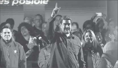  ?? (Reuters photo) ?? Venezuela’s President Nicolas Maduro raises a finger whiles surrounded by supporters as he speaks during a gathering after the results of the election were announced