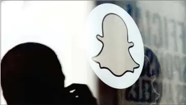  ?? KEVORK DJANSEZIAN/GETTY IMAGES NORTH AMERICA/AFP ?? A logo of Snapchat is seen at the front entrance of the company’s new headquarte­rs on November 14, 2013, in Venice, California.