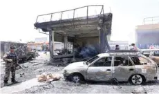  ?? — Reuters ?? Afghan security forces inspect the site of a suicide attack in Jalalabad city on Tuesday.