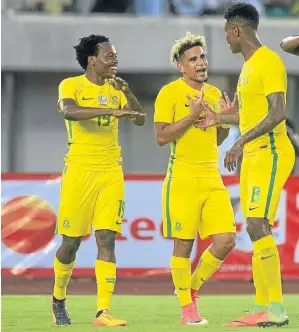  ?? /Kabiru Abubakar/ BackpagePi­x ?? Percy Tau, Keagan Dolly and Bongani Zungu celebrate a goal in the 2019 Afcon qualifier against Nigeria.