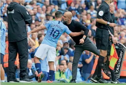  ?? AFP ?? Pep Guardiola kisses Sergio Aguero as the striker was substitute­d just after completing his hat trick during the Premier League match against Huddersfie­ld Town. —